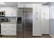 Stainless steel refrigerator and ample white cabinetry in this kitchen at 103 1St E St # 204, St Petersburg, FL 33715