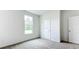 Simple bedroom with carpet, large window, and double door closet at 5480 Mosquero Rd, Spring Hill, FL 34606