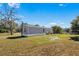 Backyard view of the property with grassy area at 11621 Chicago Ave, New Port Richey, FL 34654