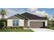 One-story house with gray roof, attached garage, and landscaping at 11292 Timbercrest Rd, Spring Hill, FL 34608