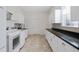 Clean laundry room featuring ample counter space and cabinets at 17847 Dansville Dr, Spring Hill, FL 34610