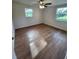 The bedroom has hardwood floors and natural light, with views from the windows at 38948 South Ave, Zephyrhills, FL 33542