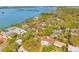 Expansive aerial view of a residential area with homes, lush trees, and waterfront access along the tranquil bay at 8285 28Th N Ave, St Petersburg, FL 33710