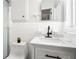 Bright bathroom features a sleek vanity with white marble countertop, matte black hardware, and a shower at 8285 28Th N Ave, St Petersburg, FL 33710