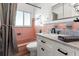 Unique bathroom with vintage pink tile, updated vanity with marble top, and stylish matte black faucet at 8285 28Th N Ave, St Petersburg, FL 33710