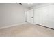 A bright bedroom with terrazzo flooring includes a closet with full-length doors and light-colored walls at 8285 28Th N Ave, St Petersburg, FL 33710