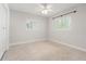 This bedroom has white walls, light-colored terrazzo flooring, and two windows with shutter-style blinds at 8285 28Th N Ave, St Petersburg, FL 33710