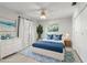 Staged bedroom featuring light blue furnishings and a neutral palette, with a beautiful aesthetic at 8285 28Th N Ave, St Petersburg, FL 33710