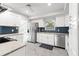 Modern kitchen with stainless steel appliances, granite countertops, and stylish blue backsplash at 8285 28Th N Ave, St Petersburg, FL 33710