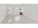 Bright living room features sleek terrazzo flooring, a front door, and natural light from the windows at 8285 28Th N Ave, St Petersburg, FL 33710