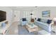 Staged living room with terrazzo floors, comfortable seating, and bright decor, virtually staged at 8285 28Th N Ave, St Petersburg, FL 33710