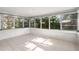 Bright sunroom features tile flooring, neutral paint, and multiple expansive windows to overlook the back yard at 8285 28Th N Ave, St Petersburg, FL 33710