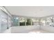 Enclosed sunroom featuring white walls, tile floors, and large windows that overlook lush landscaping at 8285 28Th N Ave, St Petersburg, FL 33710