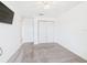 Bright carpeted bedroom featuring a closet, natural light, ceiling fan and doorway to other rooms at 1405 Blossom Bayou Cir, Ruskin, FL 33570