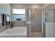 Bathroom featuring a soaking tub, separate shower with glass door, and tiled walls at 14069 Wineberry Dr, Dade City, FL 33525
