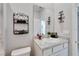 Bathroom features a single sink, white vanity, and decorative elements at 14069 Wineberry Dr, Dade City, FL 33525