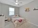 Bright bedroom featuring a ceiling fan, plush carpet, and a comfortable bed with soft linens at 14069 Wineberry Dr, Dade City, FL 33525