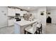 Spacious kitchen boasts white cabinets, an island with seating, and modern appliances at 14069 Wineberry Dr, Dade City, FL 33525