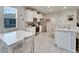 Bright kitchen with white cabinets, stainless appliances, and dining table near a window at 14069 Wineberry Dr, Dade City, FL 33525