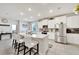 Kitchen with granite island that features seating, stainless appliances, and white cabinets at 14069 Wineberry Dr, Dade City, FL 33525