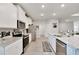 Bright kitchen with stainless appliances, white cabinets, and an island with a sink at 14069 Wineberry Dr, Dade City, FL 33525