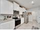 Modern kitchen features white cabinetry, stainless steel appliances, and granite countertops at 14069 Wineberry Dr, Dade City, FL 33525
