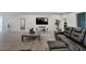 Spacious living room featuring modern decor, tile flooring and a comfortable leather couch at 14069 Wineberry Dr, Dade City, FL 33525