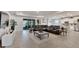 Open-concept living room featuring a plush leather sofa, neutral color palette and tile floors at 14069 Wineberry Dr, Dade City, FL 33525