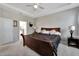 Spacious main bedroom with a tray ceiling, carpeted floor, and view to main bathroom at 14069 Wineberry Dr, Dade City, FL 33525