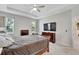 Spacious main bedroom with a tray ceiling, carpeted floor, and two side windows at 14069 Wineberry Dr, Dade City, FL 33525