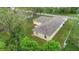 Aerial view of the property with a well-maintained roof and lush greenery surrounding the home at 3143 Grayton Dr, Spring Hill, FL 34609