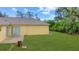 Well-maintained backyard with sliding glass doors leading to a charming patio at 3143 Grayton Dr, Spring Hill, FL 34609