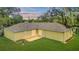 Expansive backyard featuring lush green grass and a cozy patio area for outdoor enjoyment at 3143 Grayton Dr, Spring Hill, FL 34609
