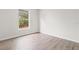 Bedroom featuring wood floors, neutral paint, and a window for natural light at 3143 Grayton Dr, Spring Hill, FL 34609