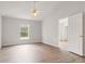 Bedroom features wood floors, neutral paint, and a large window for ample natural light at 3143 Grayton Dr, Spring Hill, FL 34609