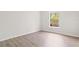 Bedroom features sleek, light gray vinyl floors and a bright window view at 3143 Grayton Dr, Spring Hill, FL 34609