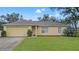 Nice one-story house with a well-kept lawn and front yard landscaping on a sunny day at 3143 Grayton Dr, Spring Hill, FL 34609