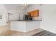 Open-concept kitchen with granite countertops, stainless appliances, and versatile breakfast bar for casual dining at 3143 Grayton Dr, Spring Hill, FL 34609