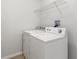 Laundry area with washer, dryer, and wire shelving for storage at 3143 Grayton Dr, Spring Hill, FL 34609
