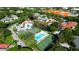 An aerial view of the community with multiple tennis courts and a sparkling pool surrounded by lush greenery at 4655 46Th Street Ct # 101, Bradenton, FL 34210