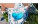 Stunning aerial view of community pool and spa with an abundance of lounge chairs and manicured landscaping at 4655 46Th Street Ct # 101, Bradenton, FL 34210