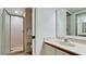 Bathroom with a glass-enclosed shower and a vanity with a sink and a large mirror at 4655 46Th Street Ct # 101, Bradenton, FL 34210