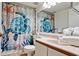 The bathroom features a turtle-themed shower curtain, stacked towels, and bright lighting at 4655 46Th Street Ct # 101, Bradenton, FL 34210