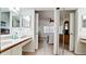 Bathroom showing dual sinks and a view into the bedroom behind sliding doors at 4655 46Th Street Ct # 101, Bradenton, FL 34210