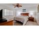 Cozy bedroom features a ceiling fan, natural light, and a comfortable queen-sized bed at 4655 46Th Street Ct # 101, Bradenton, FL 34210