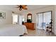 Inviting bedroom with a ceiling fan, tiled floor, and a sliding glass door leading to a patio at 4655 46Th Street Ct # 101, Bradenton, FL 34210