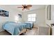 Bright bedroom features twin beds, tiled floors, and a window with natural light at 4655 46Th Street Ct # 101, Bradenton, FL 34210