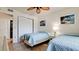 Comfortable bedroom featuring twin beds, tropical wall art, ceiling fan, and a closet at 4655 46Th Street Ct # 101, Bradenton, FL 34210