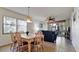 Cozy dining area with seating for six, adjacent to a living space with views of the screened patio at 4655 46Th Street Ct # 101, Bradenton, FL 34210