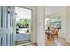 View of the dining area through the front door with a small table and wicker chairs at 4655 46Th Street Ct # 101, Bradenton, FL 34210